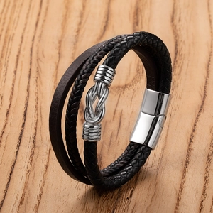 Macro view of multi-layer leather bracelet with silver anchor knot and magnetic clasp