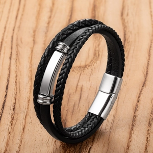Macro detail of men's multi-layer braided leather bracelet with stainless steel magnetic clasp