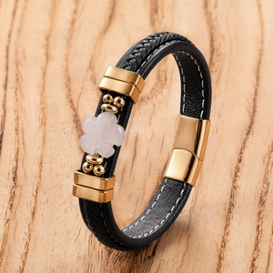 Black woven leather bracelet with golden flower charm and magnetic clasp closure
