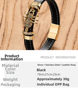 Detail of gold spider charm with colorful stones on black braided leather bracelet