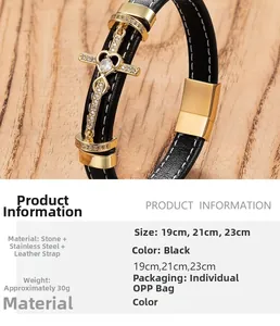 Detail of black braided leather bracelet with golden stainless steel cross and heart charm