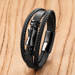 Men's multi-layer black leather bracelet with magnetic metal clasp on wood background