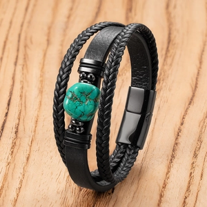 Men's bohemian multilayer braided leather bracelet with turquoise stone on wood backdrop