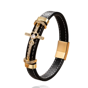 Men's black braided leather cross bracelet with gold metal accents and magnetic clasp