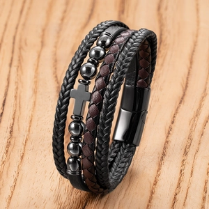 Detail view of multi-layer leather braid bracelet with polished beads and cross charm