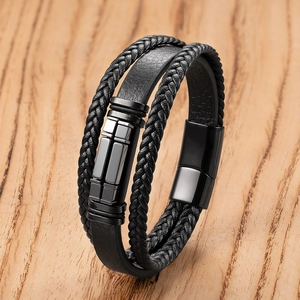 Close-up of black multilayer braided leather bracelet with magnetic metal clasp and studs