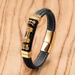 Detail of men's black leather braid bracelet with gold dumbbell 'LIVE LIFT' charm