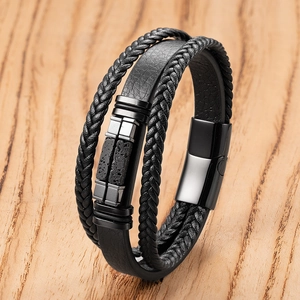 Detail of multi-layer men's leather bracelet with woven rope and magnetic steel buckle