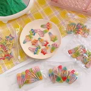 Detailed view of 10-piece gradient star hair clips with glitter in a storage bag