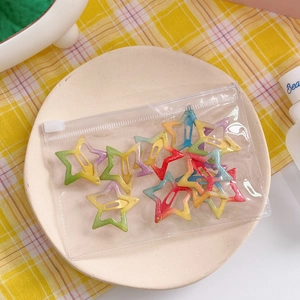 Detailed shot of gradient rainbow star hair clips in a transparent frosted storage pouch