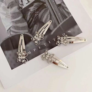 Set of four silver butterfly hair clips with sparkling rhinestones for women