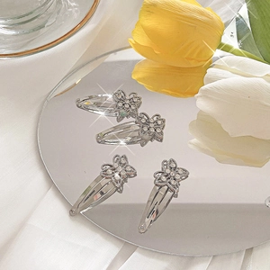 Set of four silver butterfly hair clips with sparkling rhinestones for stylish girls