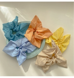 Close-up of colorful pastel scrunchies in cotton fabric and sweet Korean style floral shapes