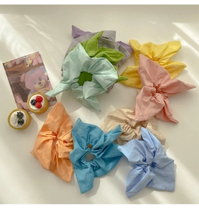 Detail of colorful cotton scrunchies in pastel macaron shades with rabbit ear bow design