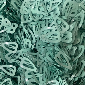 Pile of mini 2cm mint green drop-shaped metal hair clips with high-quality paint finish