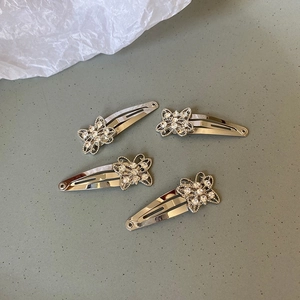 Detailed view of silver butterfly hair clips set with sparkling rhinestones decoration