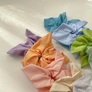 Set of colorful macaron scrunchies with cute rabbit ear bows in soft cotton fabric