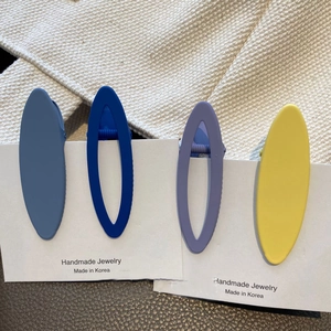 Set of four matte oval hair clips in Morandi colors on a white display card
