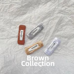 Detailed view of four handmade brown series BB hair clips with woven thread texture