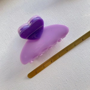 Detail shot of a purple heart hair claw clip on a ruler showing 5-6cm size length