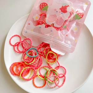 Detailed macro of colorful high-elasticity hair ties in a cute pink rabbit packaging bag