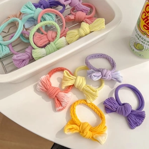 Close-up of pastel macaron-colored bow hair ties with pleated fabric texture set