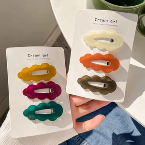 Set of 6 colorful cloud-shaped wave hair clips in warm autumn colors on display cards