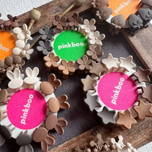Mini matte earth tone hair claws in flower and star shapes on display cards