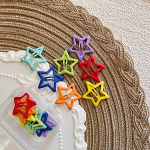Set of colorful star-shaped matte metal BB hair clips for kids in a clear storage box