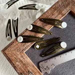 Retro bronze drop clips for girls featuring white decorative floral details, 5cm length