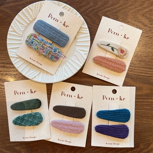 Detail view of 10-piece plaid tweed and corduroy hair clip set in vintage colors