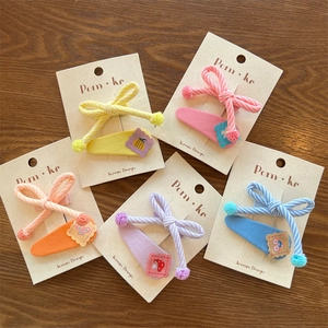 Detailed set of colorful striped bow hair clips with cute cartoon embroidery for girls