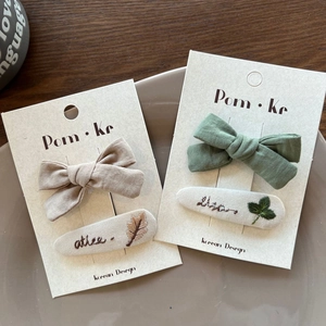 Detailed embroidery of leaves on fabric hair clips in a vintage Korean style set