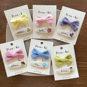Handmade embroidered bow hair clips with floral and fruit patterns in macaron colors
