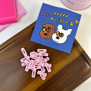 Bulk set of mini 2cm pink glossy lacquer snap hair clips on a wooden tray for girls