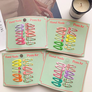 Detail showing 10-piece matte mini BB hair clips with floral and fruit patterns
