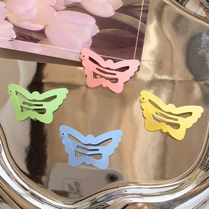 Macaron color butterfly hair clips set in matte finish metal on a silver tray