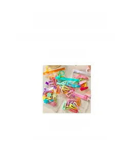 Detail of candy-colored kids' hair clips in flower and triangle shapes with size specs