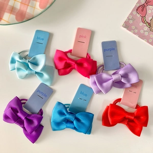 Set of 6 colorful bow hair ties for girls featuring ribbed texture and high elasticity