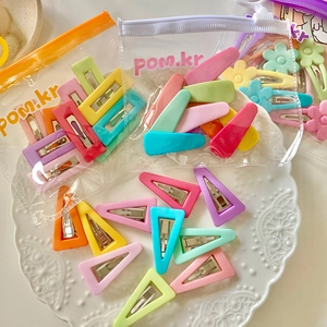 Colorful macaron hair clips set with matte flower and geometric shapes in a PVC bag