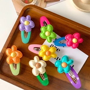 7-piece set of colorful resin flower hair clips for girls on a wooden display tray
