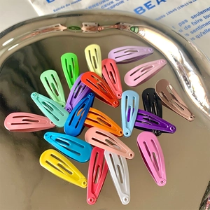 Colorful 3cm teardrop snap hair clips in candy colors on a modern silver display tray