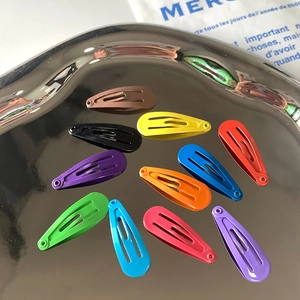 Set of 11 colorful 3cm matte metal BB snap hair clips for girls on a silver tray