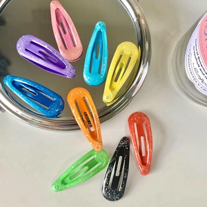Set of 9 colorful glitter snap hair clips for kids in various vibrant shades and finishes