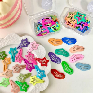 Set of colorful mini heart and star-shaped metal hair clips in a clear storage box