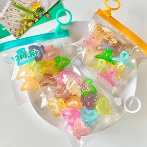 Close-up of colorful heart and butterfly hair clips in a portable zipper pouch