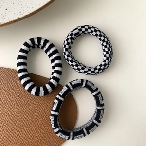 Three-piece set of knit checkerboard and striped hair ties in black and white colors