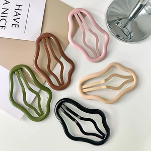 Set of five wavy candy-colored matte hollow hair clips in pink, brown, green, and beige
