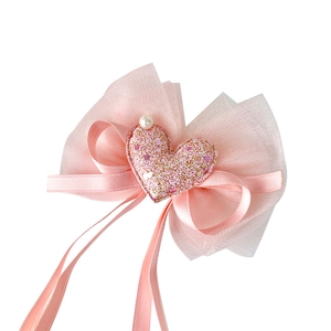 Pink ribbon bow hair clip with organza layers and a sparkling heart center for girls