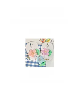 Detailed view of floral hair clips with dimensions 6.3cm by 5cm in pastel colors